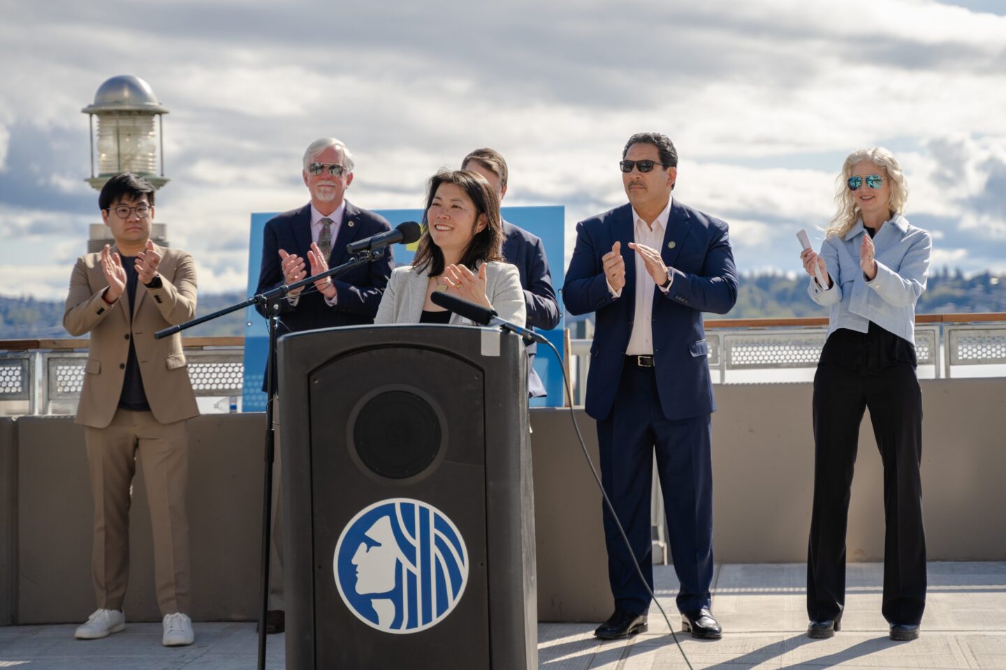 Joy Shigaki, President & CEO of Friends, speaks at the Elliott Way Opening and Dzidzilalich Honorary Naming among other city and community leaders including Mayor Bruce Harrell.  Photo by Jo Cosme.
