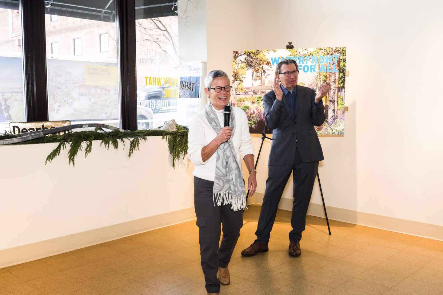 Friends board chair
Maggie Walker (foreground) and former Seattle mayor Charlie Royer speaking at the Pier 62 groundbreaking event at Waterfront Space in 2017.
