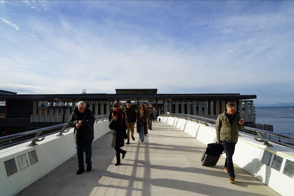 People walk towards downtown Seattle from Colman Dock on the new Marion Street Pedestrian Bridge.