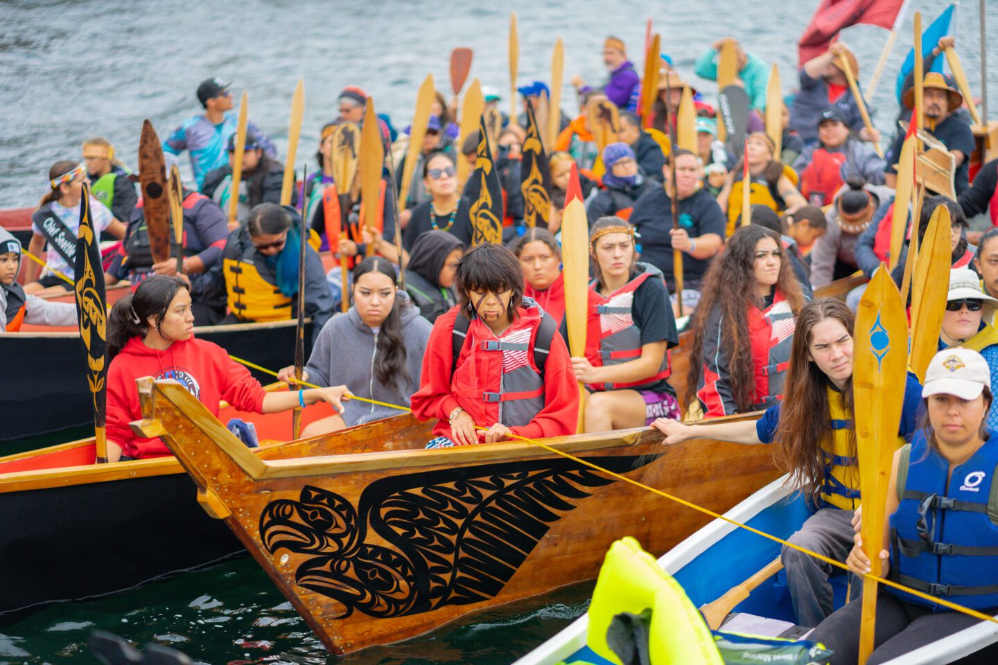 Members of various Tribal Nations float on the Sound in their canoes.