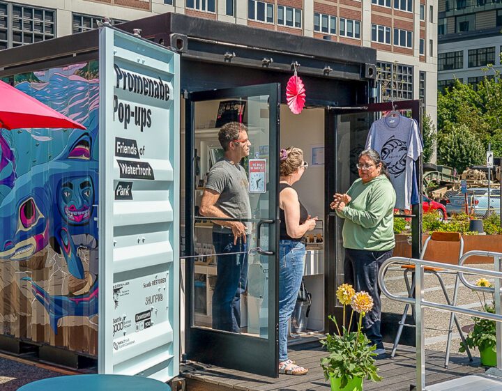 A vendor at the Promenade Pop-up having a conversation with two shoppers.