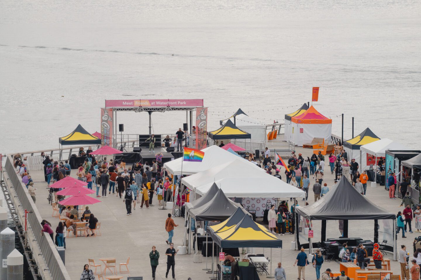 Aerial scene from the Indigiqueer Festival at Waterfront Park — a joyful celebration of Two-Spirit and Indigiqueer identity, culture, and community, hosted on Pier 62. Photo by Jo Cosme