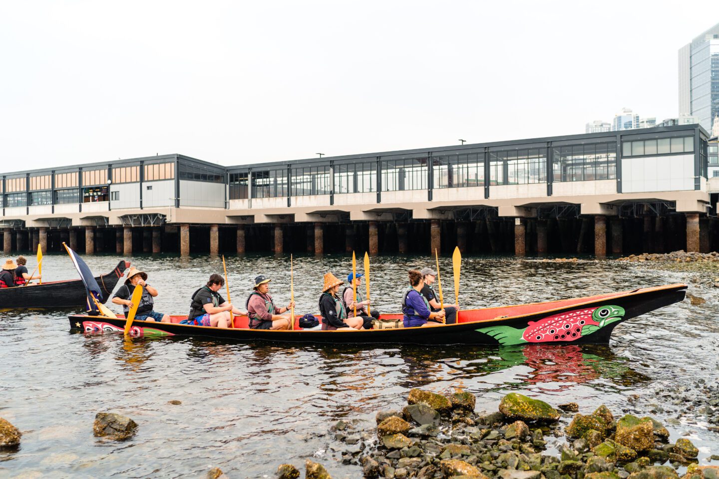 Suquamish tribe arrives on a canoe to Habitat Beach.