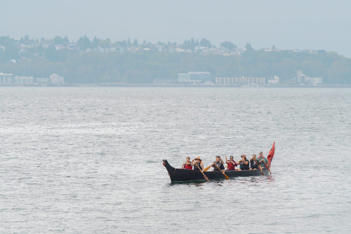 Suquamish tribe arriving on a canoe from Salish Sea.