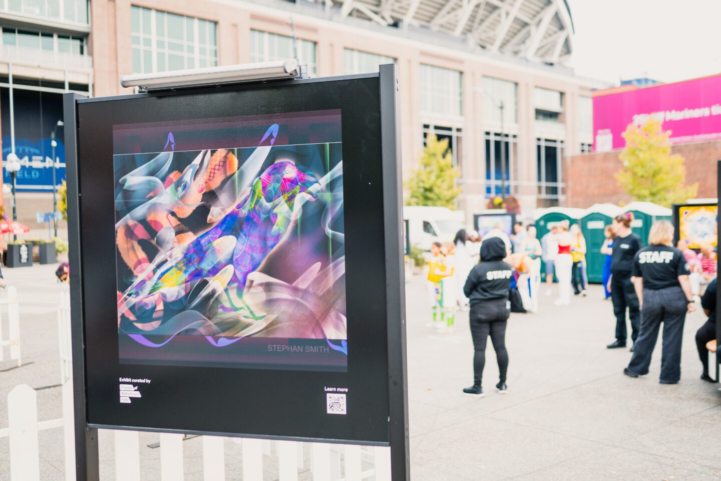 Art piece with people standing behind it.