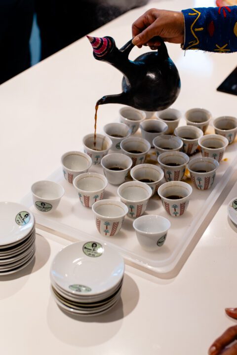 Freshly poured cups of coffee are shared during a ceremonial tasting.