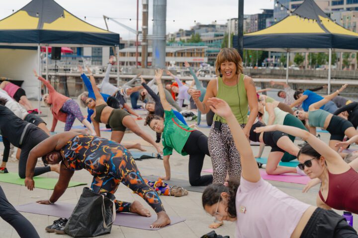A yoga instructor walking between yogis.
