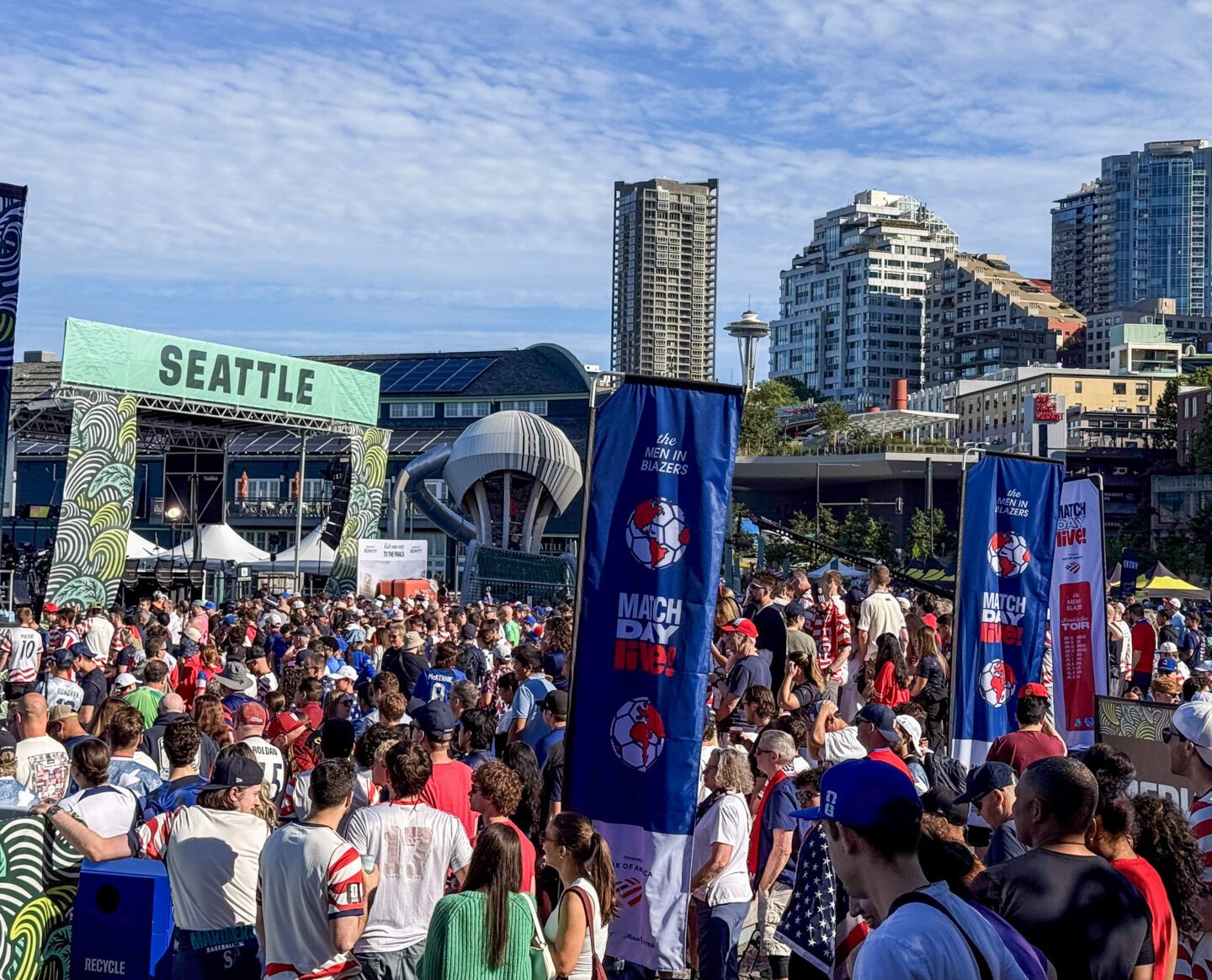A crowd of people standing in front of a large stage.