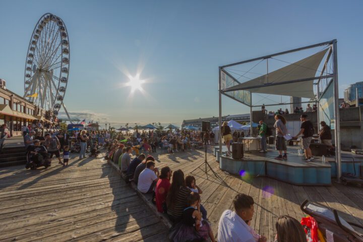 A crowd of people watching a performance on a stage.