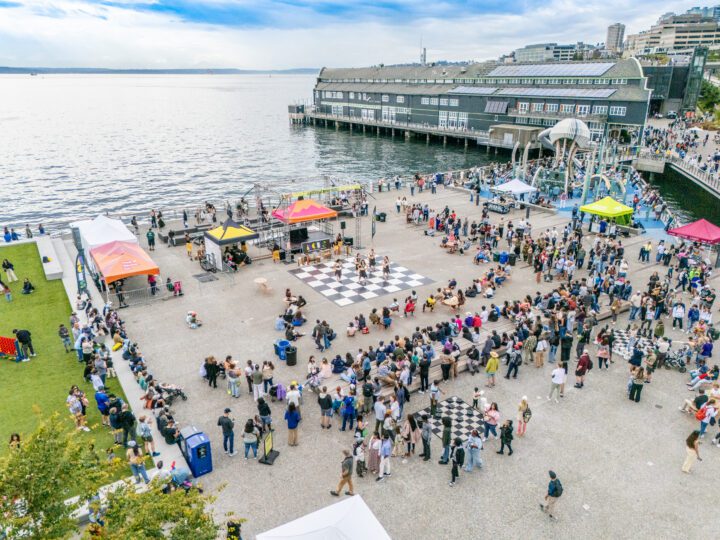 A crowd of people watching a performance on a checkered dance floor at Pier 58.